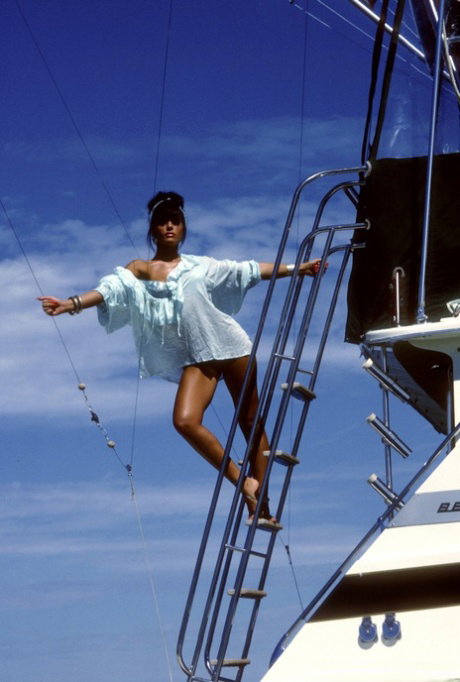 Sexy babe Stevie Jean uncovers her small breasts and shiny butt on a boat