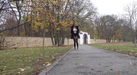Caucasian girl Maddi Black takes a piss up against a tree in a park
