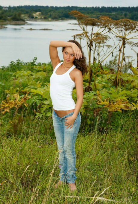 Barely legal girl Macarena J works her tight ass after getting naked in bushes