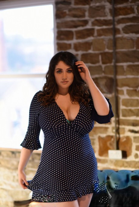 Thick brunette Bella B reveals her large melons and poses topless