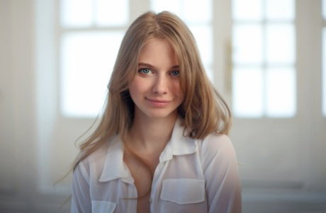 Beautiful blonde teen Siya gets naked while wearing white stockings