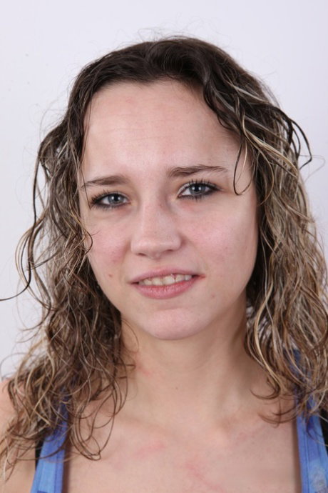 Amateur girl Tereza stands fully clothed before sitting on a stool in the nude