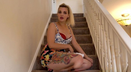 Tattooed blonde takes off her underwear during upskirt action on the stairs
