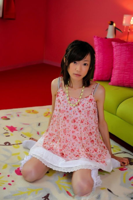 Petite Japanese girl with a pretty face models non nude in knee socks