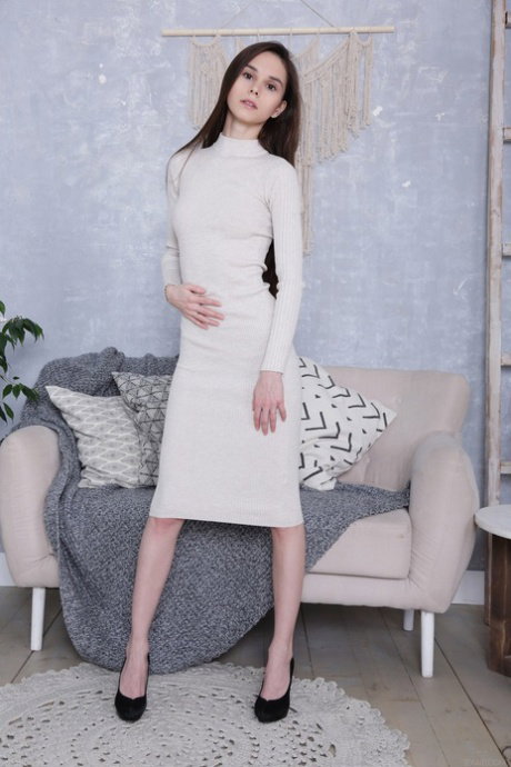 Russian teen Leona Mia lifts her dress up and fingers her sweet pussy