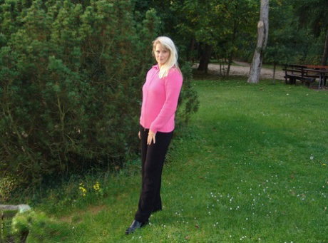 Older blonde woman Sweetsusi strips naked on public playground