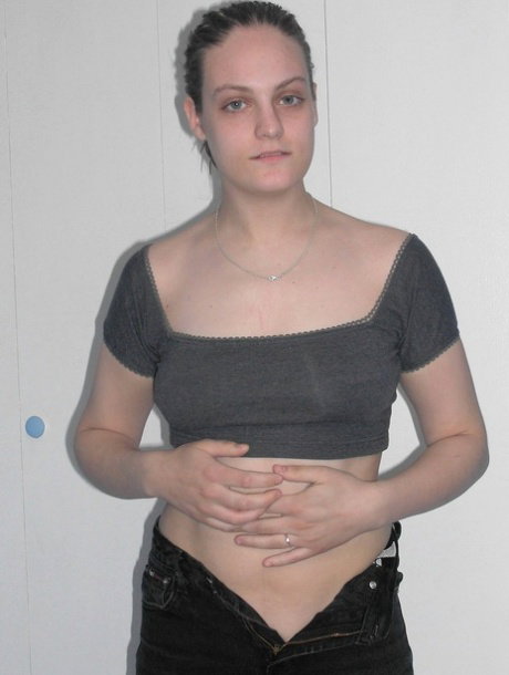 Brunette amateur Danni flaunts her small tits & gets her body messy with paint