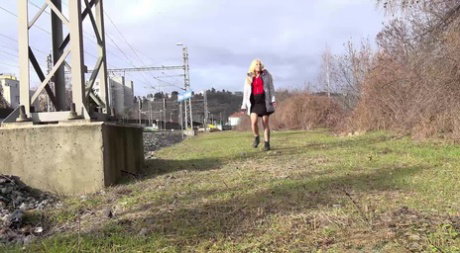 Blonde MILF Caroli takes a badly needed piss near a hydro tower