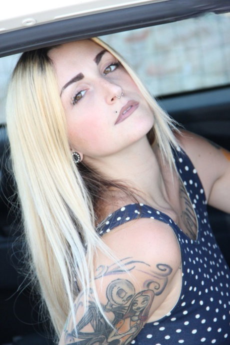 Tattooed girl Medusa Blonde shows her bare feet and ass while in a car