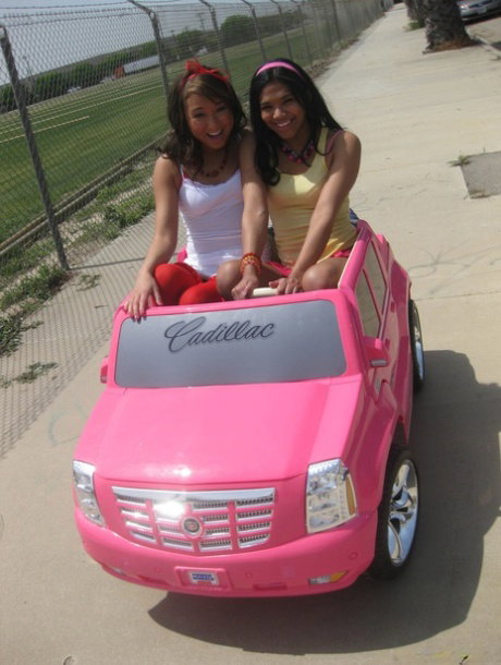 Sassy sweeties Jesse & Emy flaunt petite oiled ass while playing in toy car