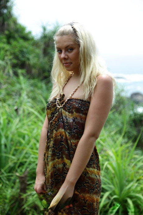 Blonde teen Shani gets totally naked outdoors in an inviting manner