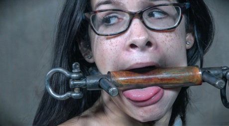 Brunette chick Eden Sin is fitted with a gag while restrained