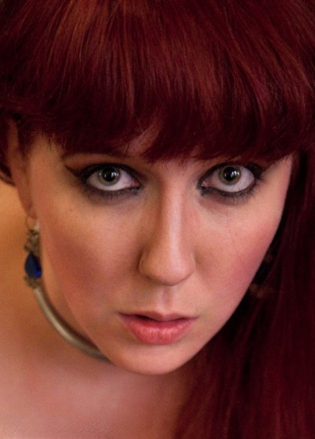 Busty redhead is penetrated while serving as a sex slave to a couple